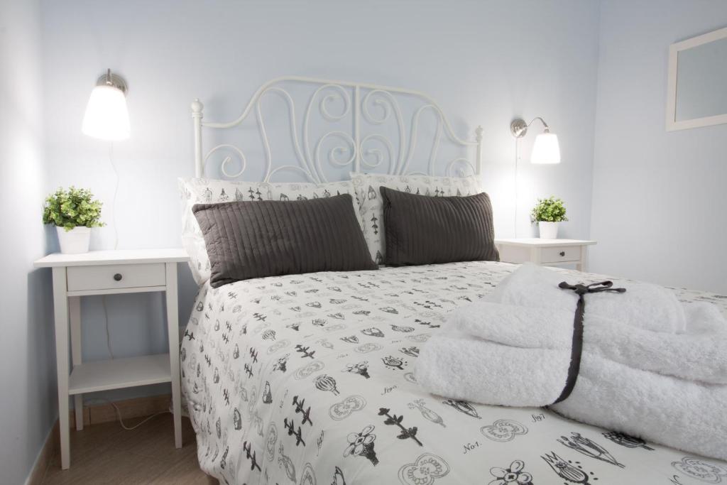 una camera con letto bianco e testiera blu di Casa Turchese Unmarediblu a San Vito lo Capo