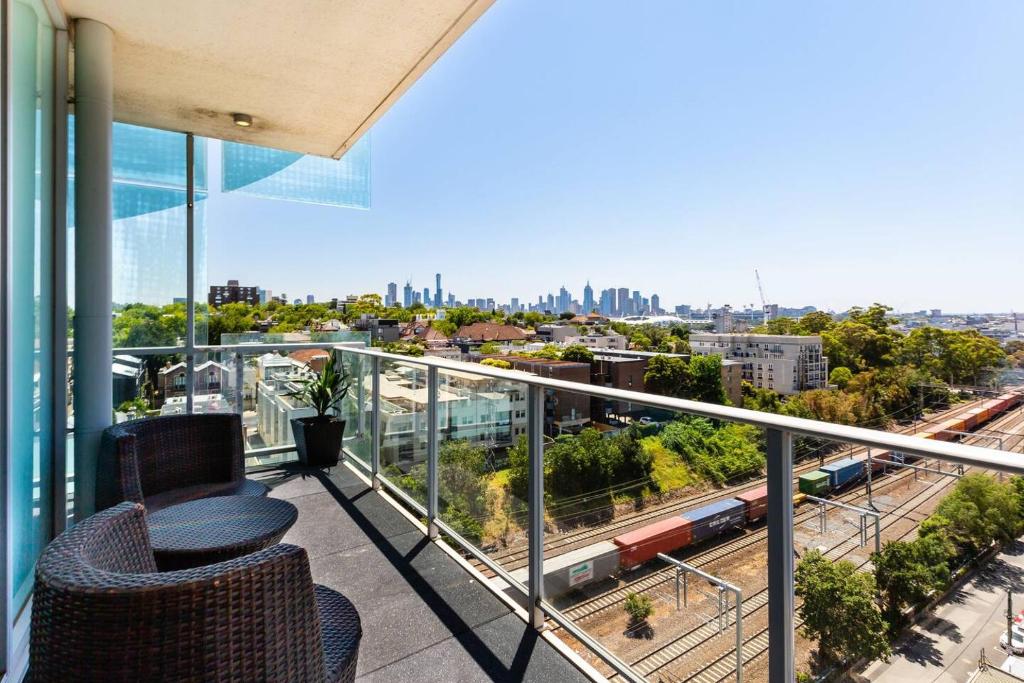 a balcony with a view of a train at City View Chic in South Yarra with Parking in Melbourne