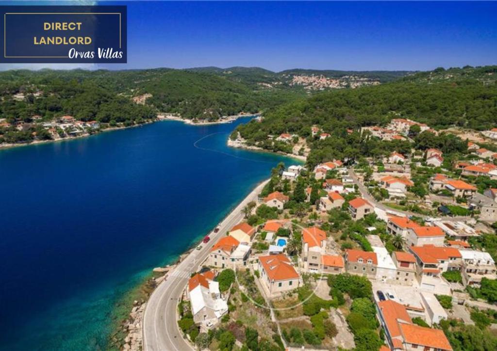 an aerial view of a town next to a lake at Seafront Serenity Villa Mir Vami - Your Family Oasis by the Shore in Sumartin