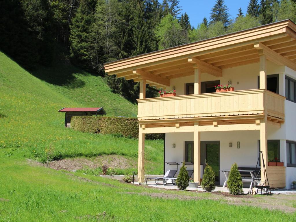 キルヒベルク・イン・チロルにあるCharming Apartment in Kirchberg in Tirol with Private Gardenの大家(椅子付きポーチ付)