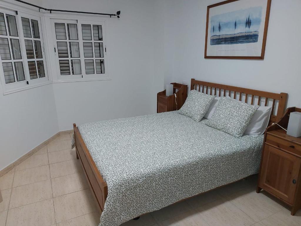 a bedroom with a bed and a window at NIVARIA SUITE in Vecindario