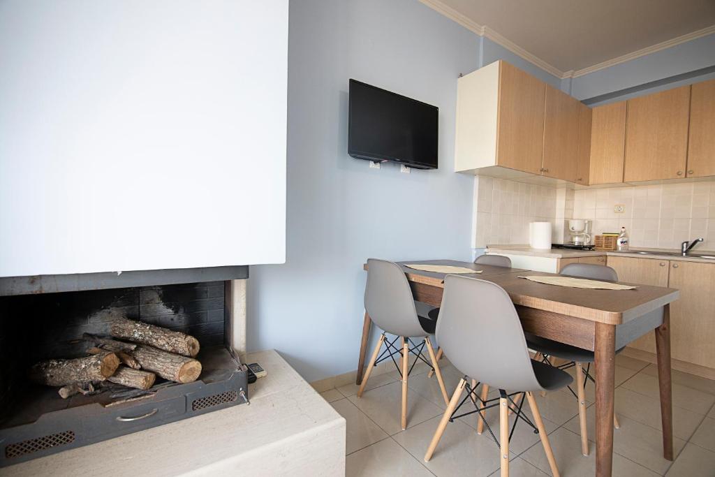a kitchen with a table and a fireplace in a room at PTapartment4 in Perea
