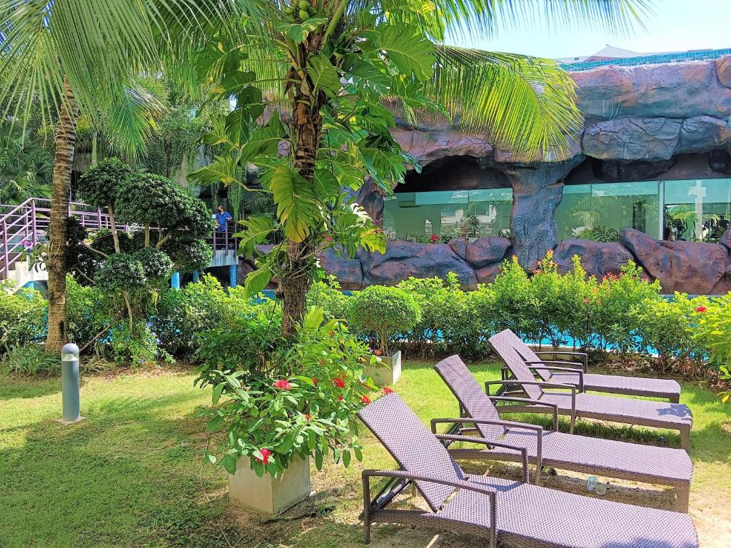 a group of chairs sitting in front of a building at Laguna Beach Resort 3 Maldives in Jomtien Beach