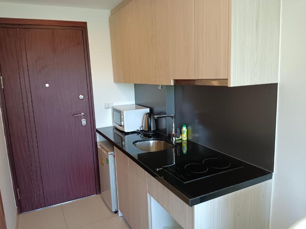 a small kitchen with a sink and a microwave at Laguna Beach Resort 3 Maldives in Jomtien Beach