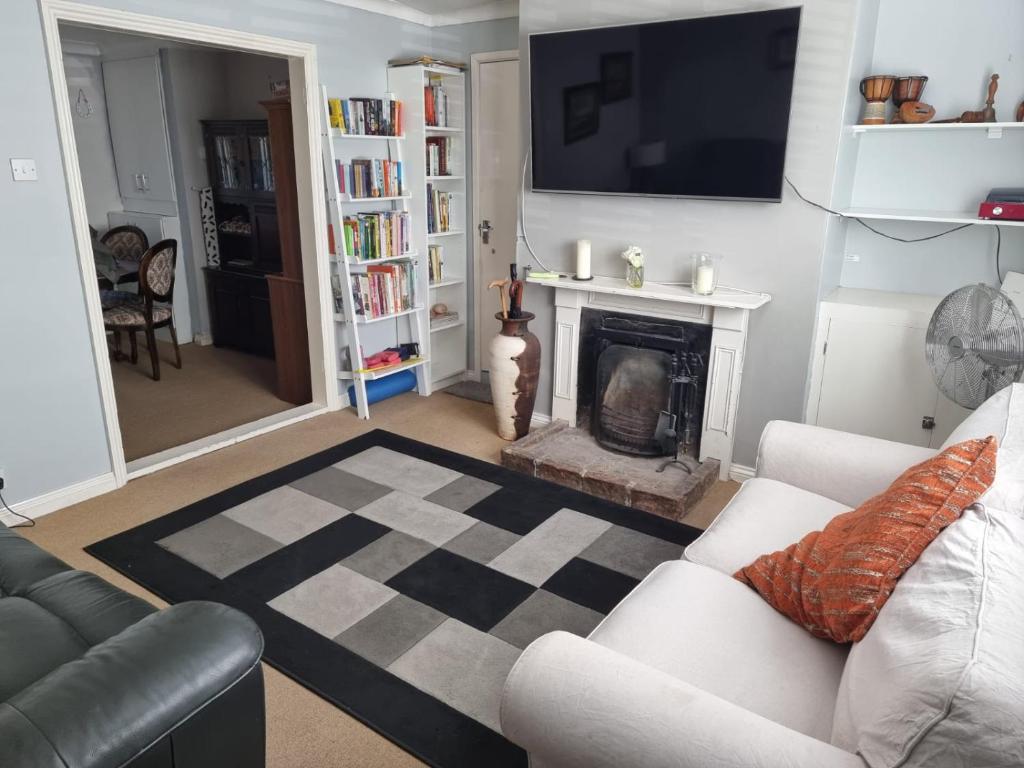 a living room with a couch and a fireplace at 31 Elwyn Road in March