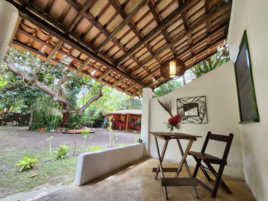 a patio with a table and a wooden ceiling at Pousada Vila Gaia in Santo André