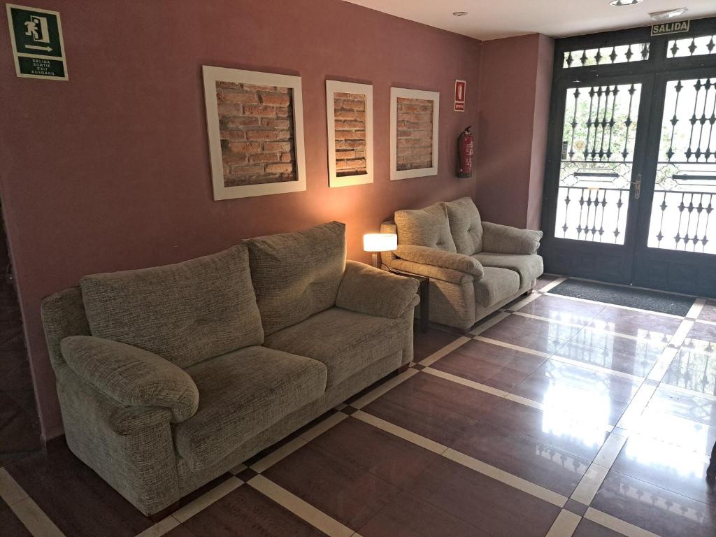 a living room with a couch and two chairs at Hotel Restaurante Ribera del Chicu in Arriondas