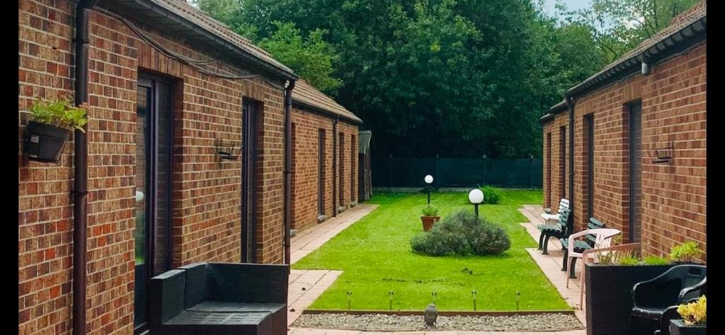a courtyard of a brick building with a garden at Carpe Diem in Jumet