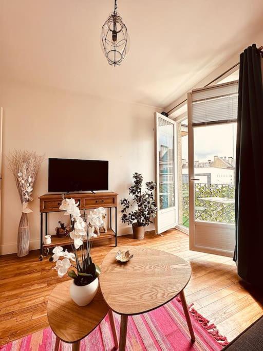 un salon avec une table et une télévision dans l'établissement Le Petit Bijou Hyper centre Sedan, à Sedan