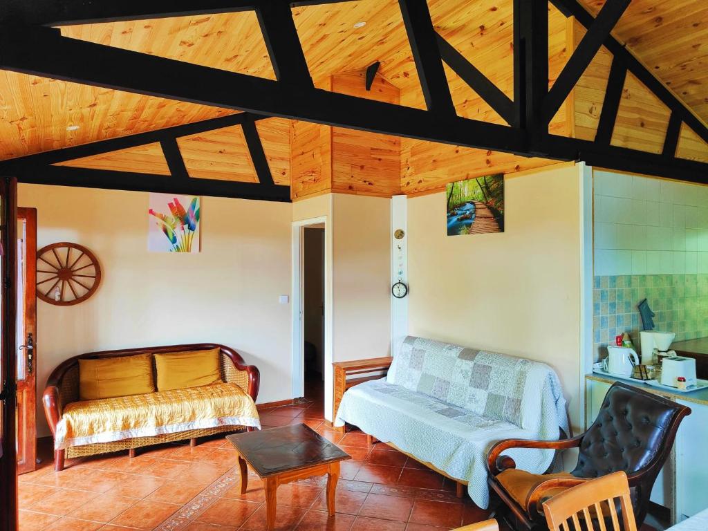 a living room with a couch and a table at Chalet Combava in Saint-Benoît