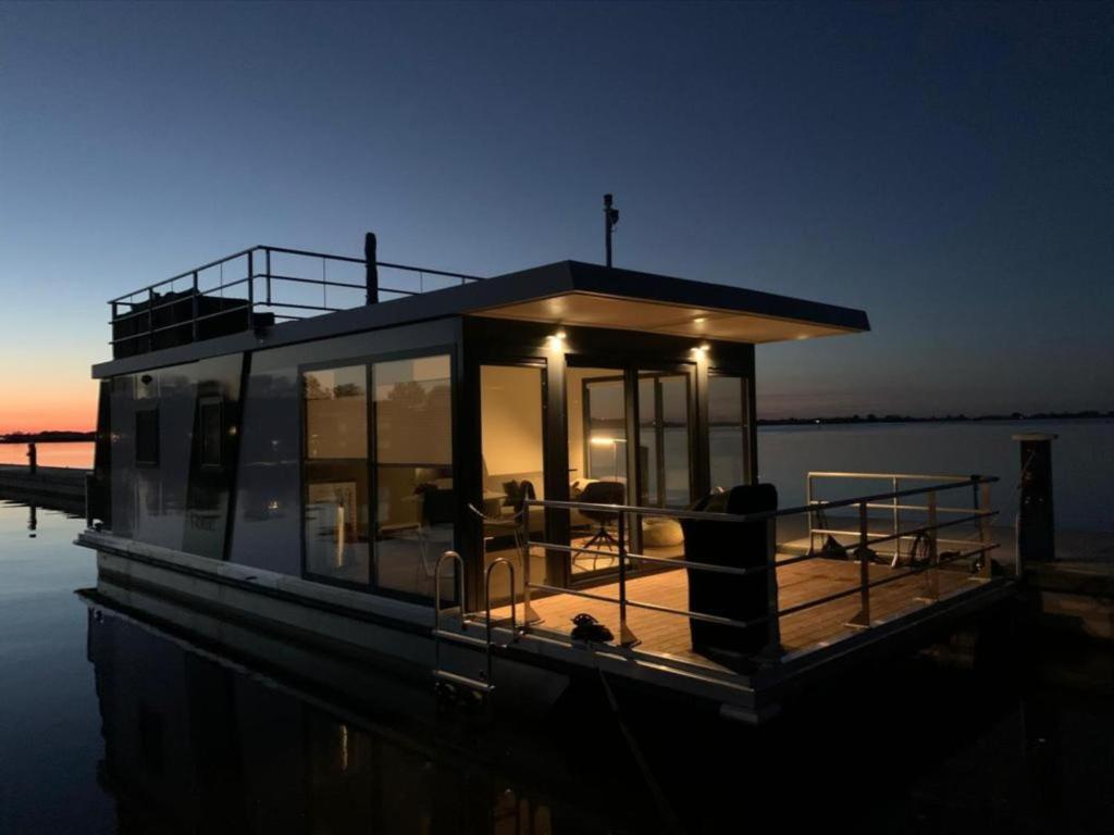 a small house on a boat in the water at Modern houseboat in Offingawier with terrace in Offingawier