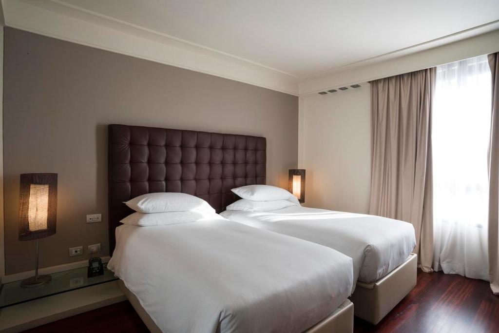 Postel nebo postele na pokoji v ubytování DoubleTree by Hilton Florence Metropole