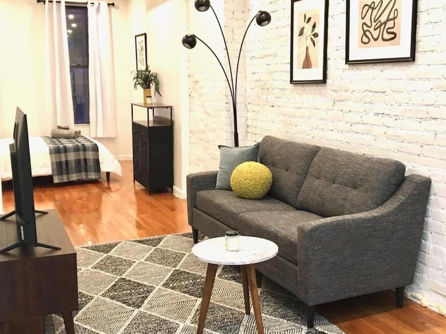 a living room with a couch and a table at Cozy Studio Chinatown! Location! in New York