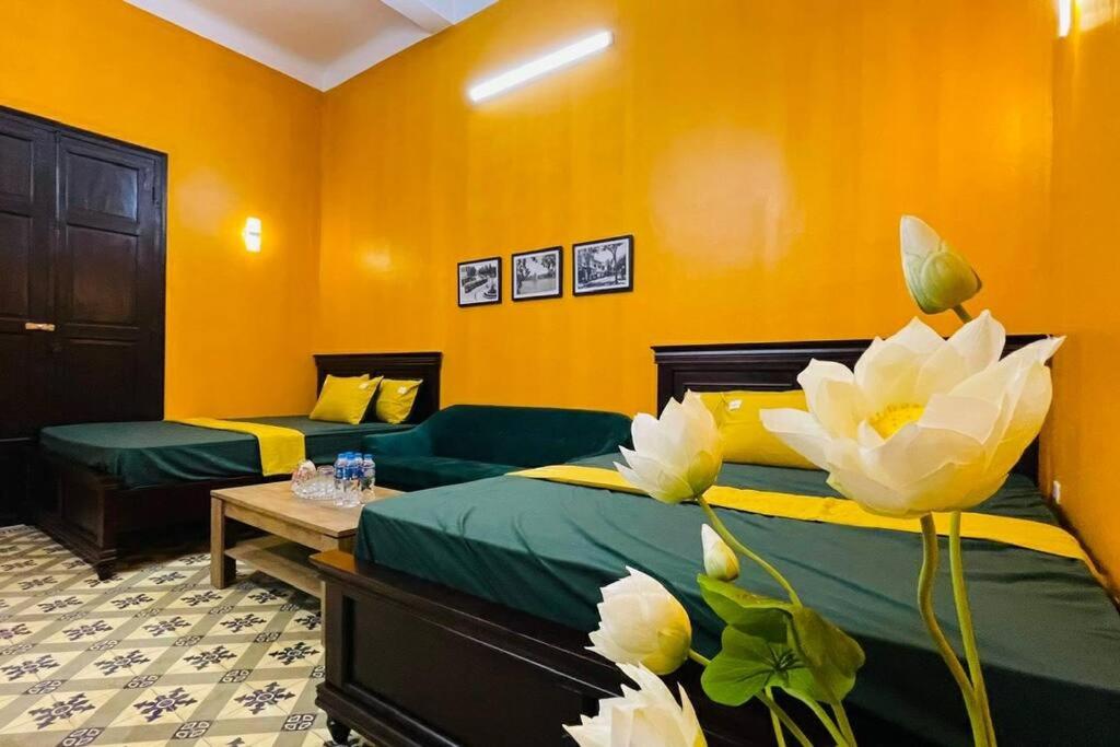 a bedroom with two beds and a couch at Old Quarter Autumn Hanoi in Hanoi