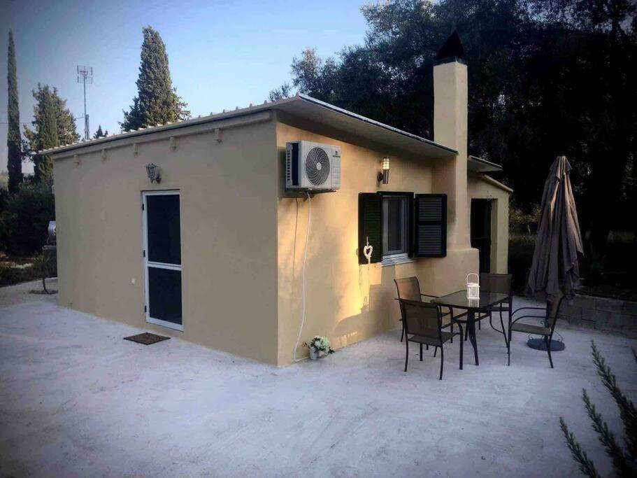 a small house with a table and chairs in front of it at g&z cottage in Kynopiástai