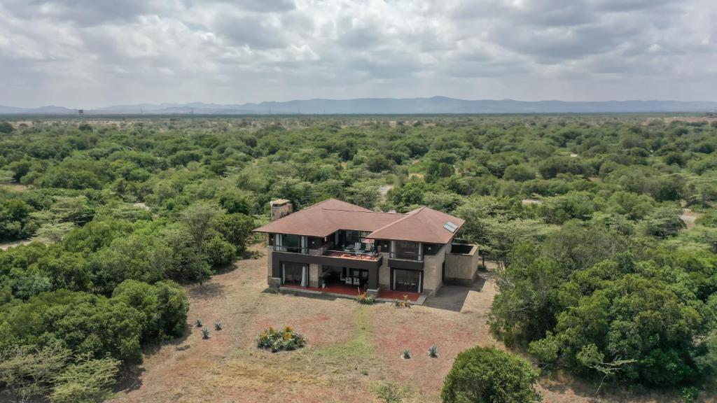 an aerial view of a house in the middle of a field at Ol Pejeta Mansion in Nanyuki