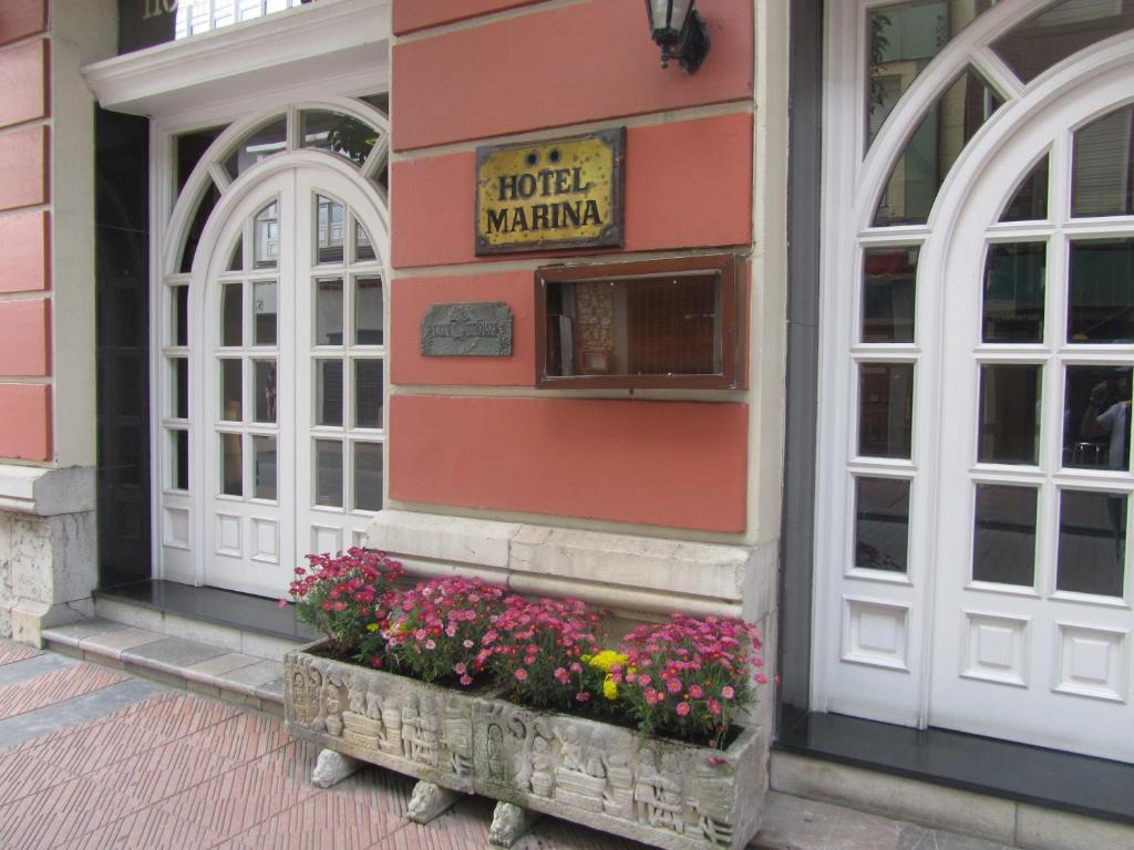 a building with flowers on the side of it at Marina in Ribadesella