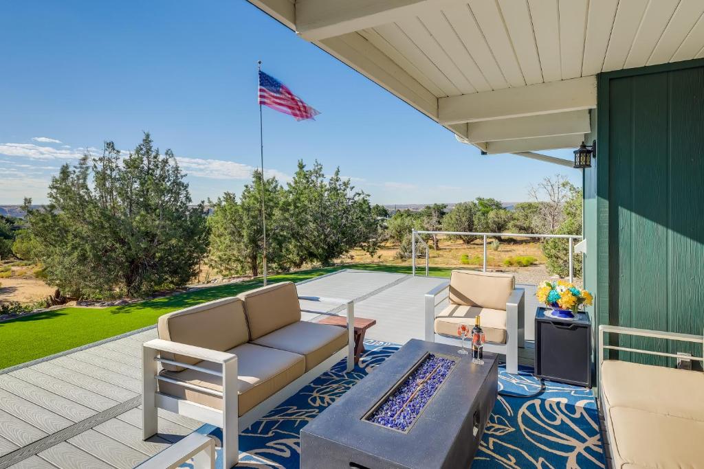 a patio with chairs and a table and an american flag at Home with Views and Fire Pit, 10 Mi to Aztec Ruins! in Farmington