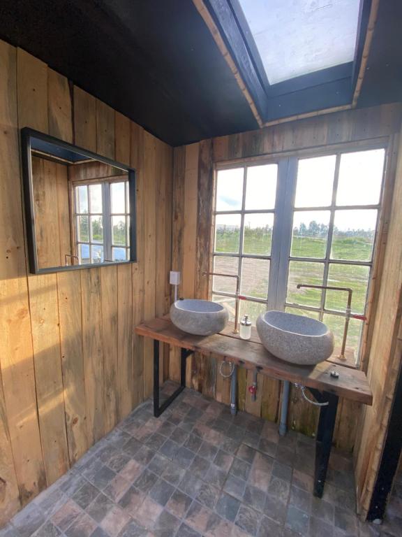 a bathroom with two sinks on a wooden counter at La Colmena Glamping in El Rosario