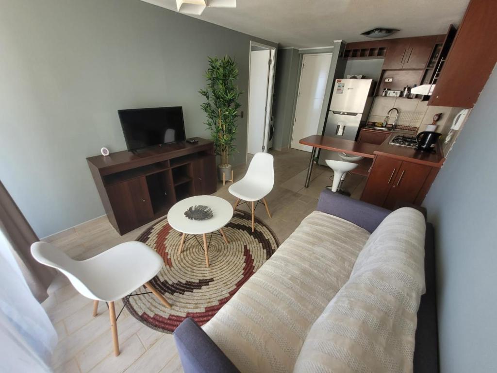 a living room with a couch and a table at Disfruta Depto. Antofagasta in Antofagasta