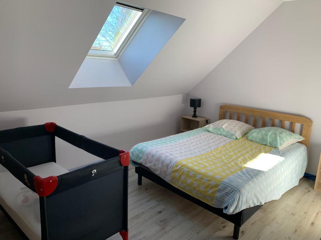 a bedroom with a bed and a window at Gîte du Busatier in Marcillac-la-Croisille