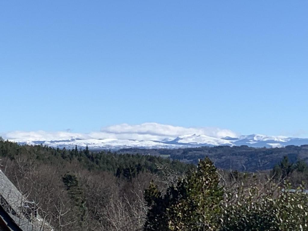 a view of snow covered mountains in the distance at Gîte du Busatier in Marcillac-la-Croisille