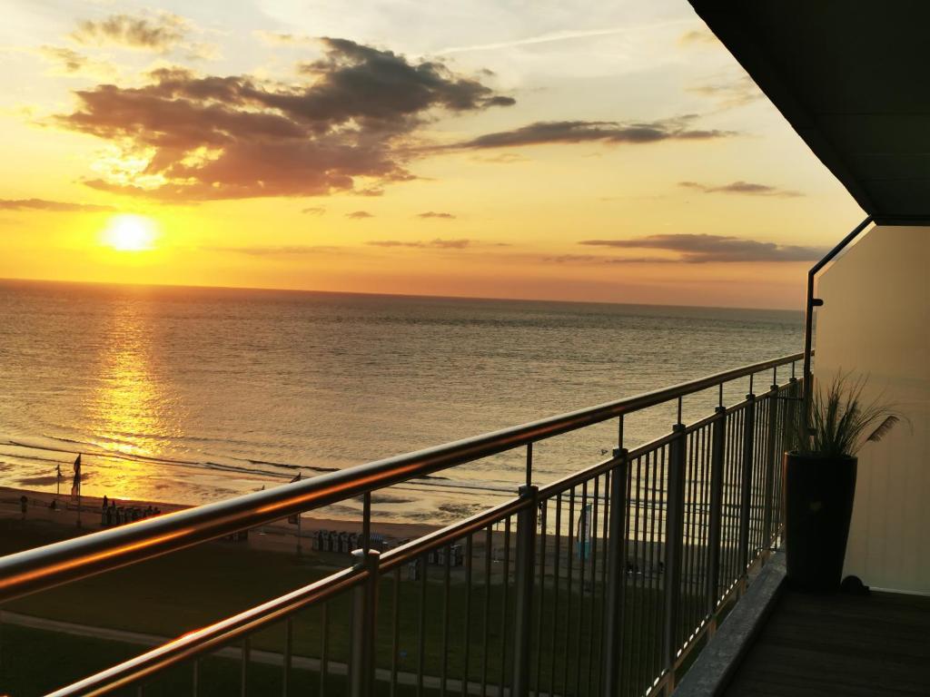 a sunset from the balcony of a condo at Kaiserhof auf Norderney in Norderney