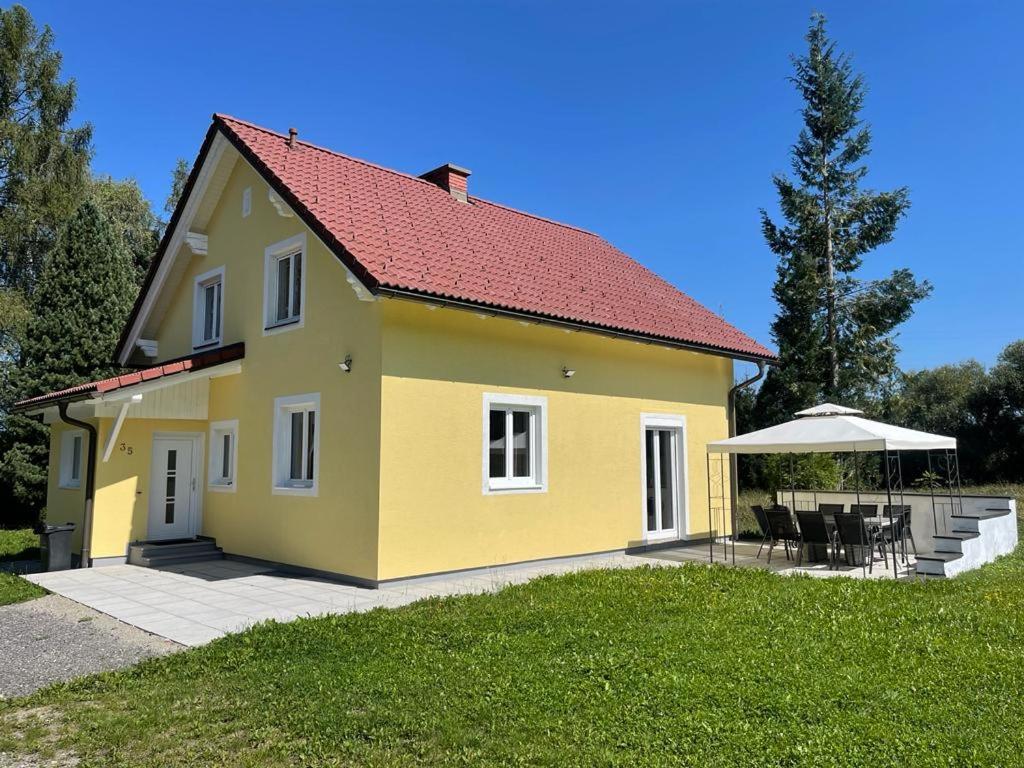 a yellow house with a red roof at Ferienhaus Murtal in Weißkirchen in Steiermark