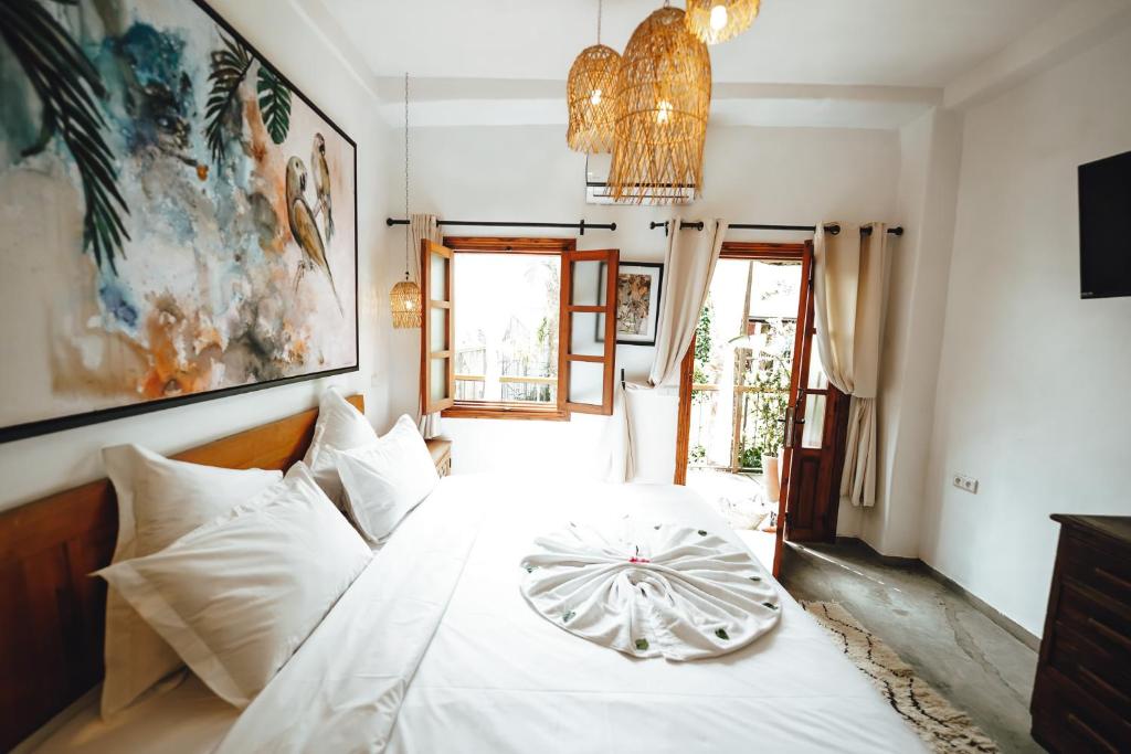 a bedroom with a white bed with a plate on it at La Ferme Medina in Marrakesh