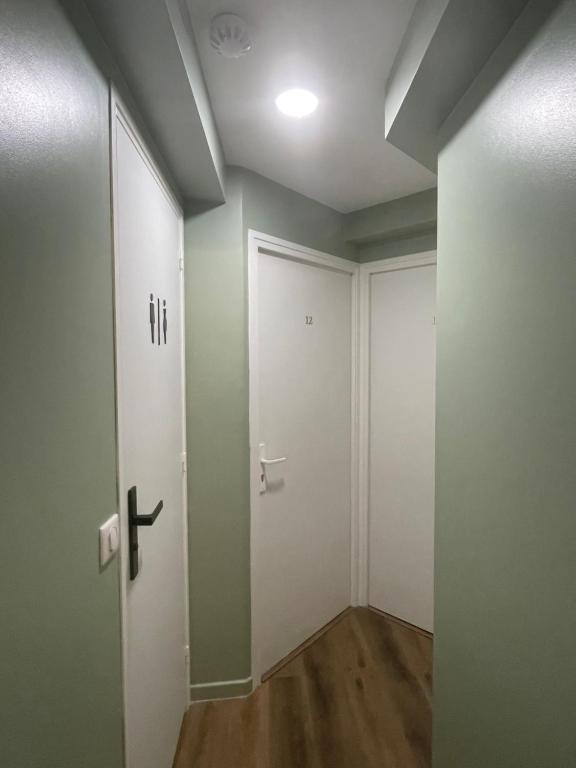 an empty room with a door and a hallway at Hôtel P.L.M. in Cannes