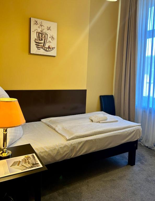 Postel nebo postele na pokoji v ubytování Hotel Adam