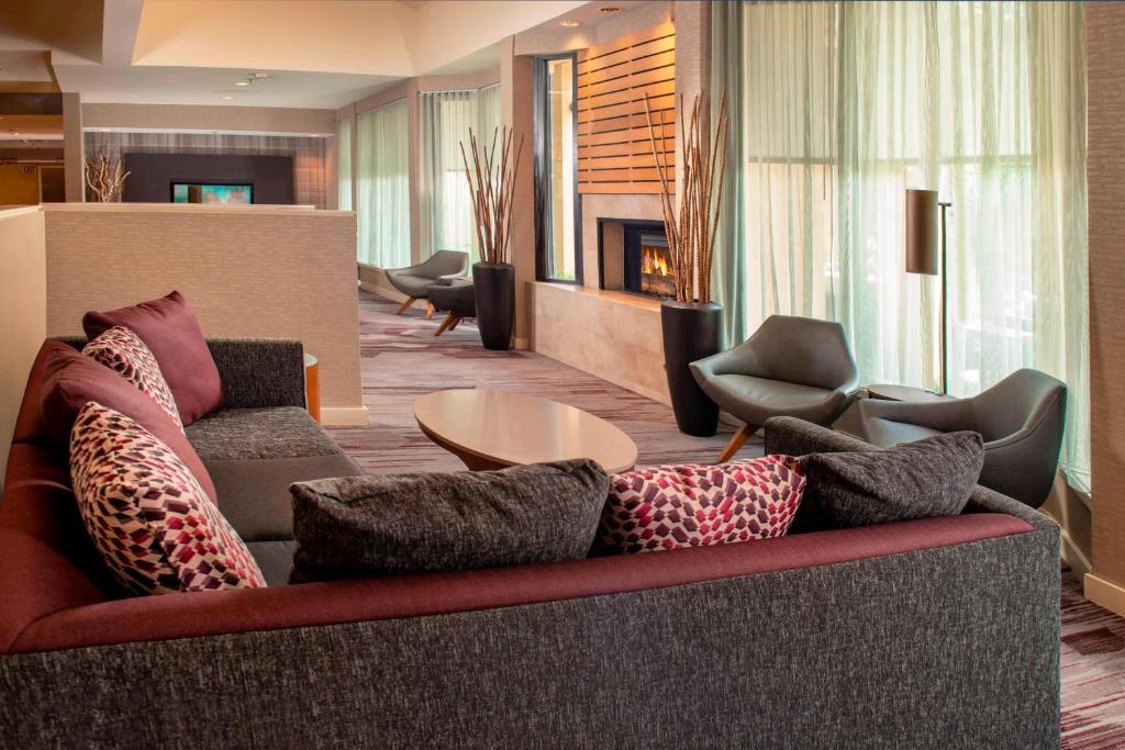 a living room with a couch with pillows on it at Courtyard by Marriott Rockville in Rockville
