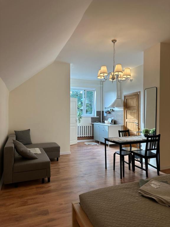 a living room with a table and a couch at Kart apart 3 in Rīga