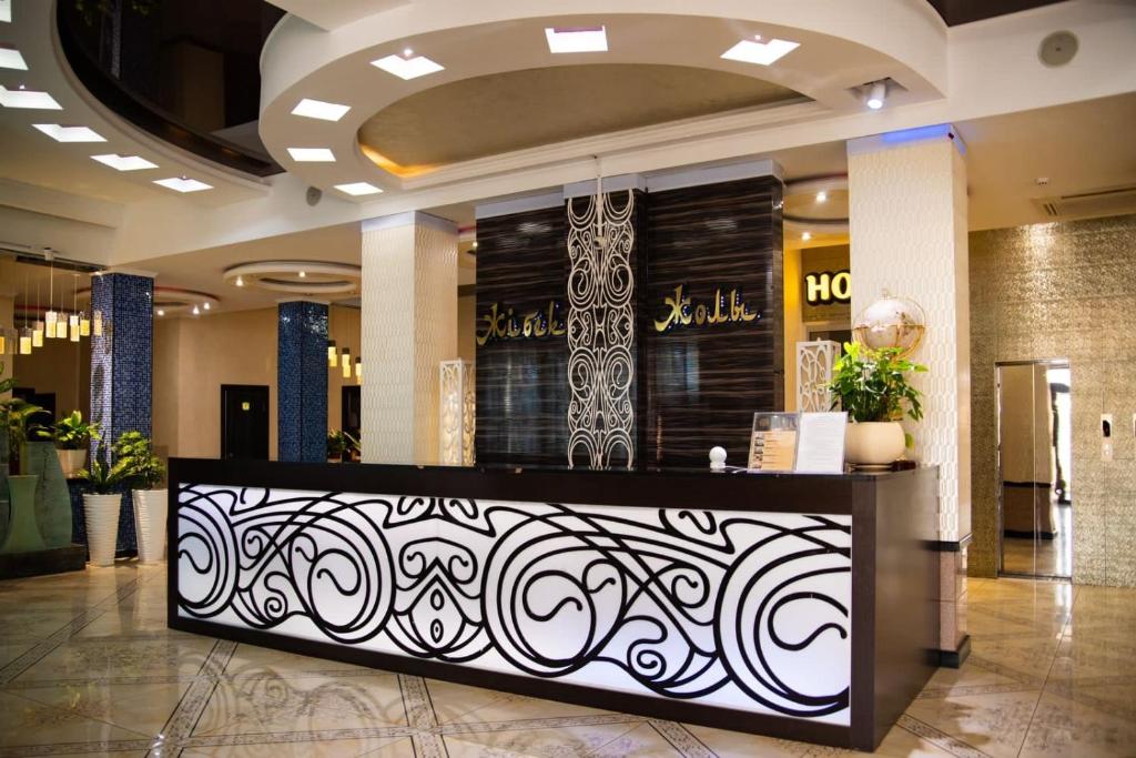 a lobby with a bar in a building at Hotel Zhibek Zholy in Shymkent