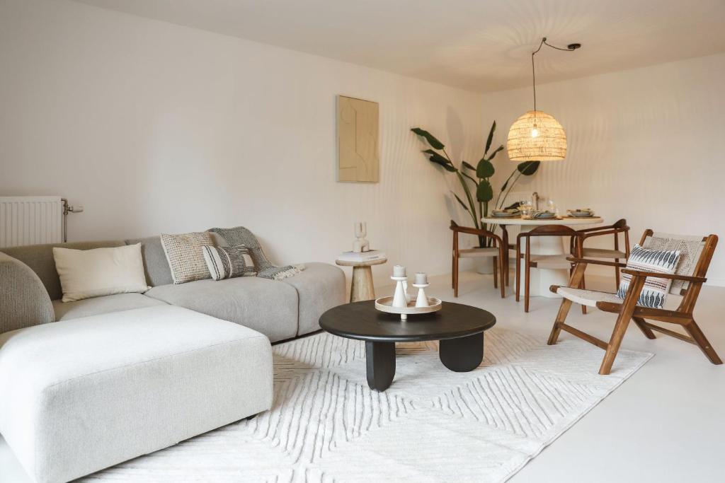 a living room with a couch and a table at Appartement in Antwerpen in Antwerp