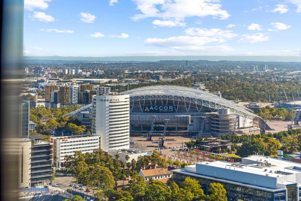 an aerial view of a soccer stadium with a building at Lovely 2 bedroom APT in centre of Sydney Olympic Park in Sydney