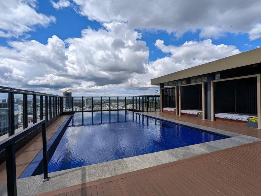 a swimming pool on the roof of a building at High Level Luxury APT in Wentworth Point in Sydney