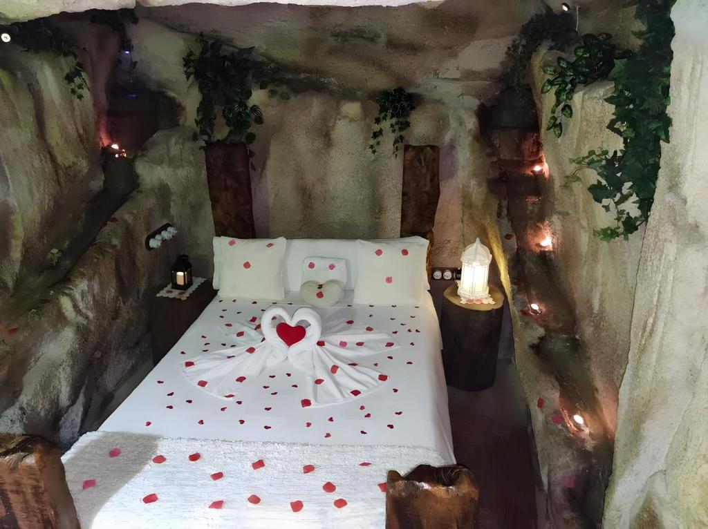 a bedroom with a bed with a heart bow on it at La Cova de Can Pavet in Pontons