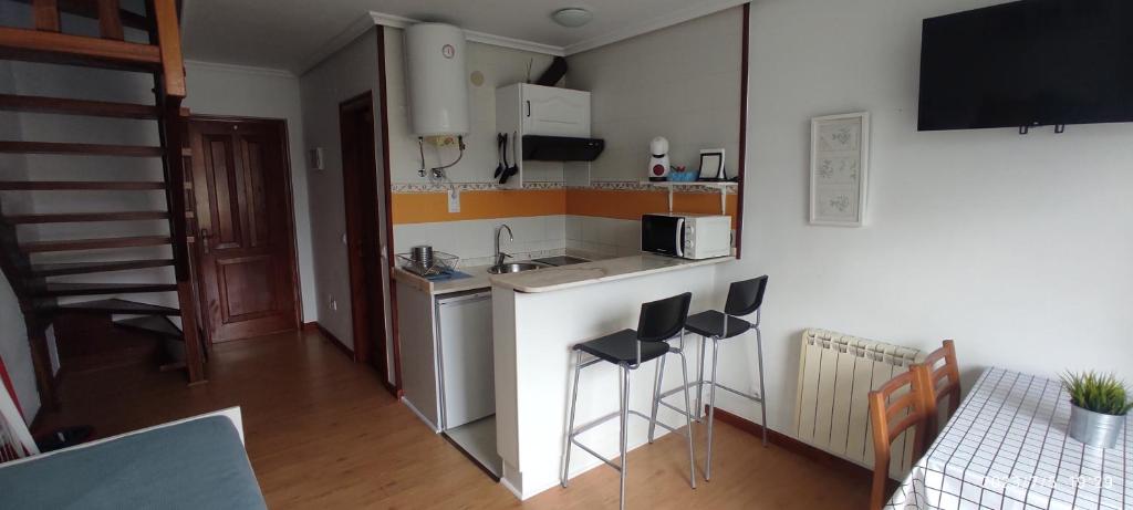 A kitchen or kitchenette at Apartamentos El Jornu
