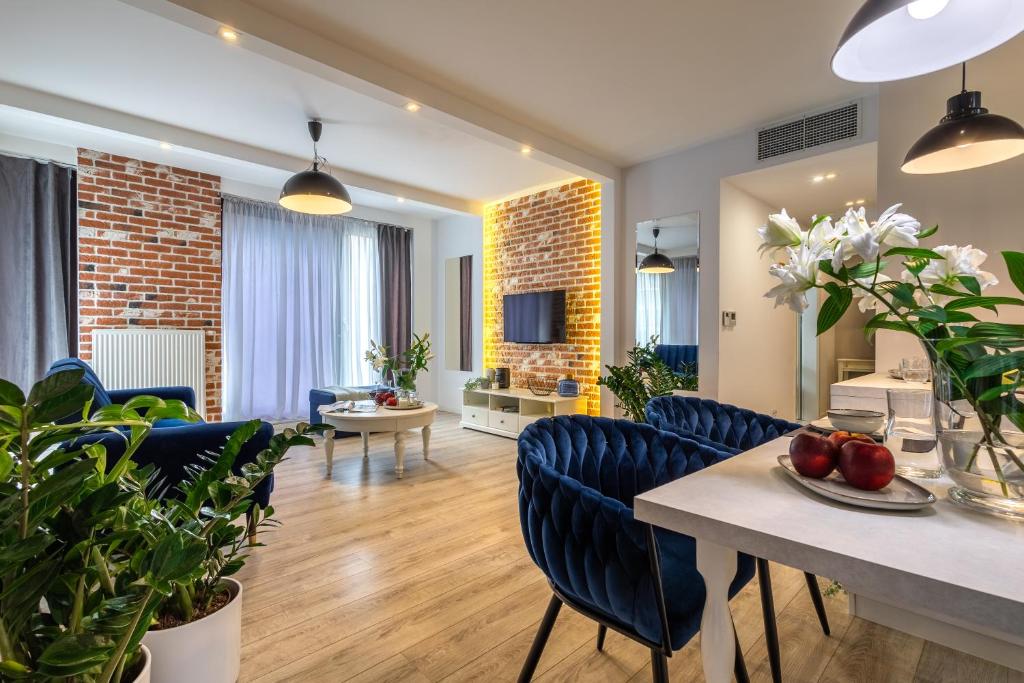 a living room with blue chairs and a dining room at AbsyntApart Krawiecka - Just in Center Wrocław Rynek in Wrocław