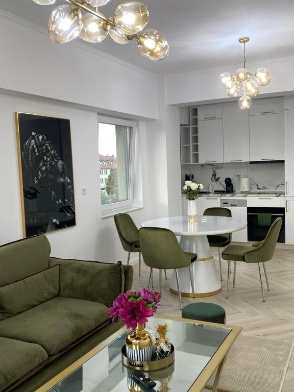 a living room with a couch and a table at Elite Apartment in Sibiu