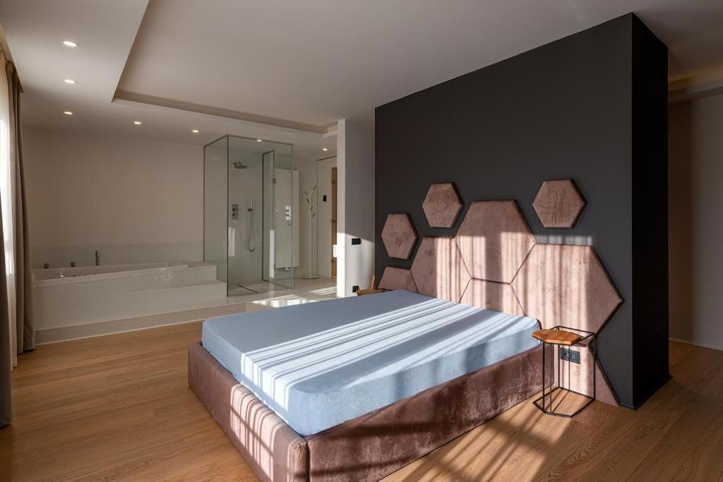 a bedroom with a large bed and a bath tub at Sauna&Jacuzzi Apartment in Cluj-Napoca