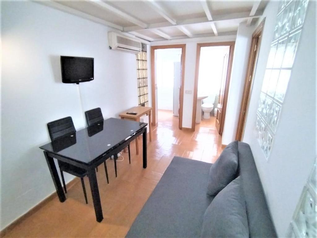 - un salon avec une table et un canapé dans l'établissement Apartamento - Puerta del Sol, à Madrid