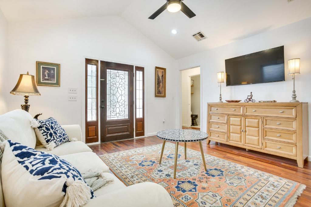 a living room with a couch and a tv at New Orleans Duplex Walk to Parks and Restaurants! in New Orleans