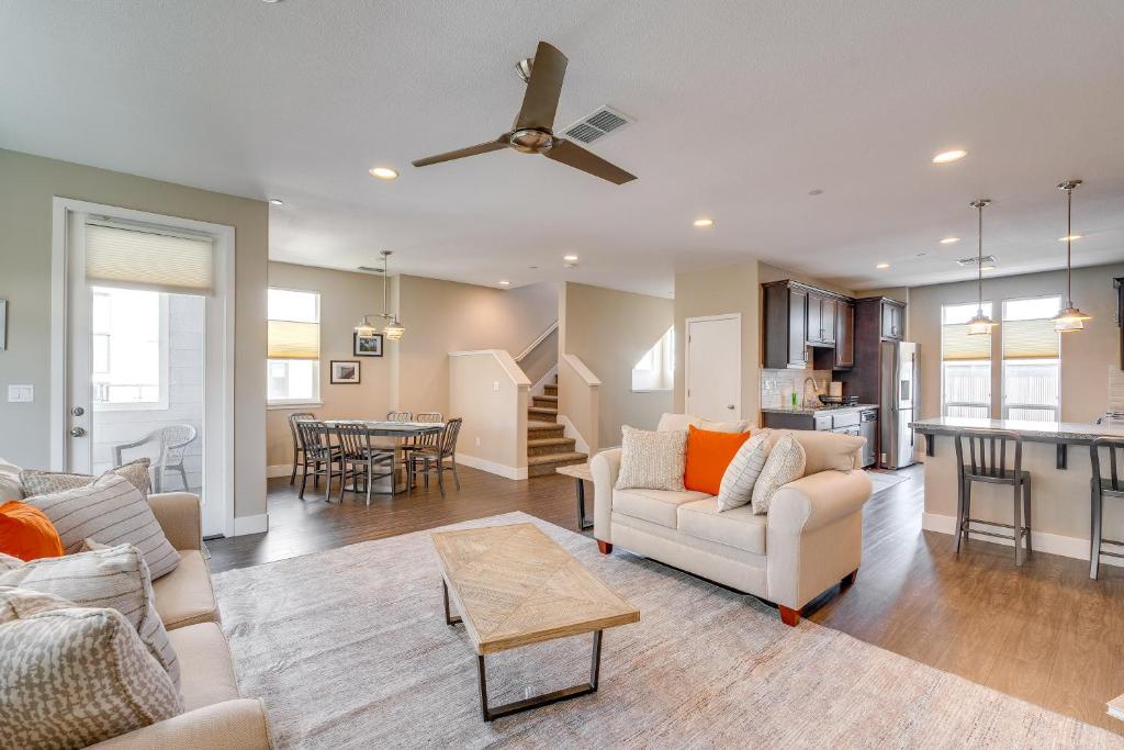 a living room with a ceiling fan and a living room at Ideally Located Sacramento Townhome with 2 Balconies in Sacramento