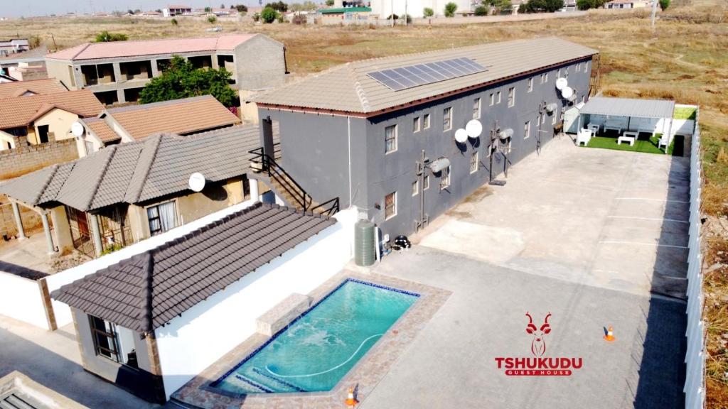 an aerial view of a house with a swimming pool at Tshukudu Guesthouse in Soweto