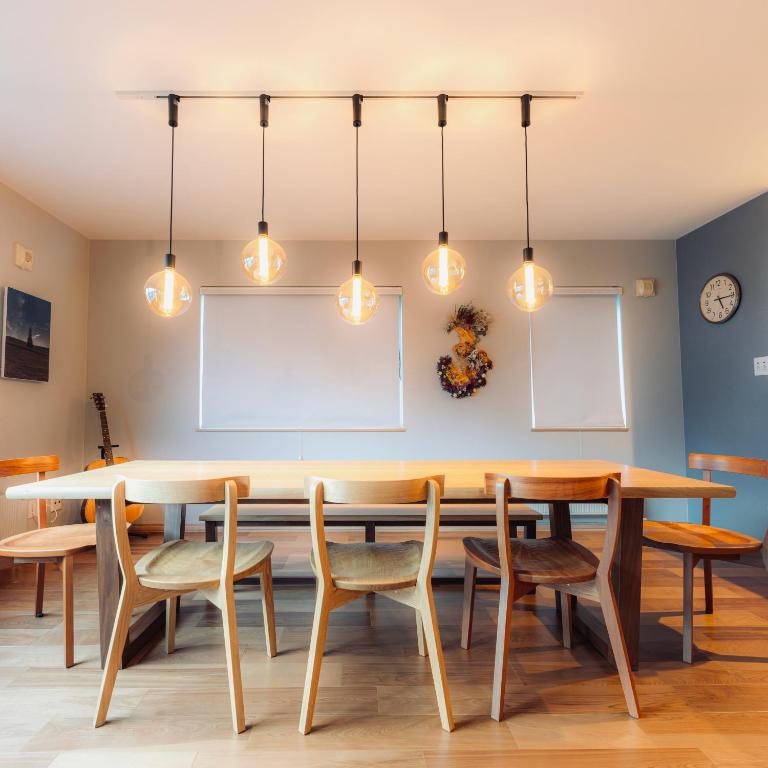 a dining room with a table and chairs at The Box House in Furano