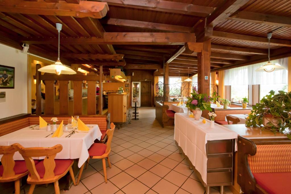 a restaurant with two tables and chairs at Gasthof Thomann in Velden am Wörthersee