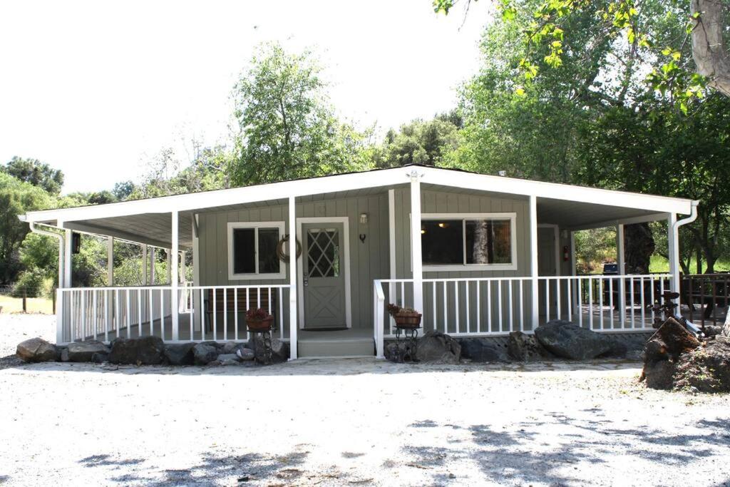 Casa pequeña con porche y valla blanca en Mill Creek Getaway, en Squaw Valley