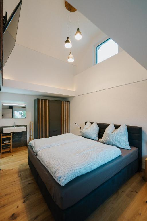 a bedroom with a bed and a desk in a room at Nockventure Ferienhaus Gnesau in Gnesau